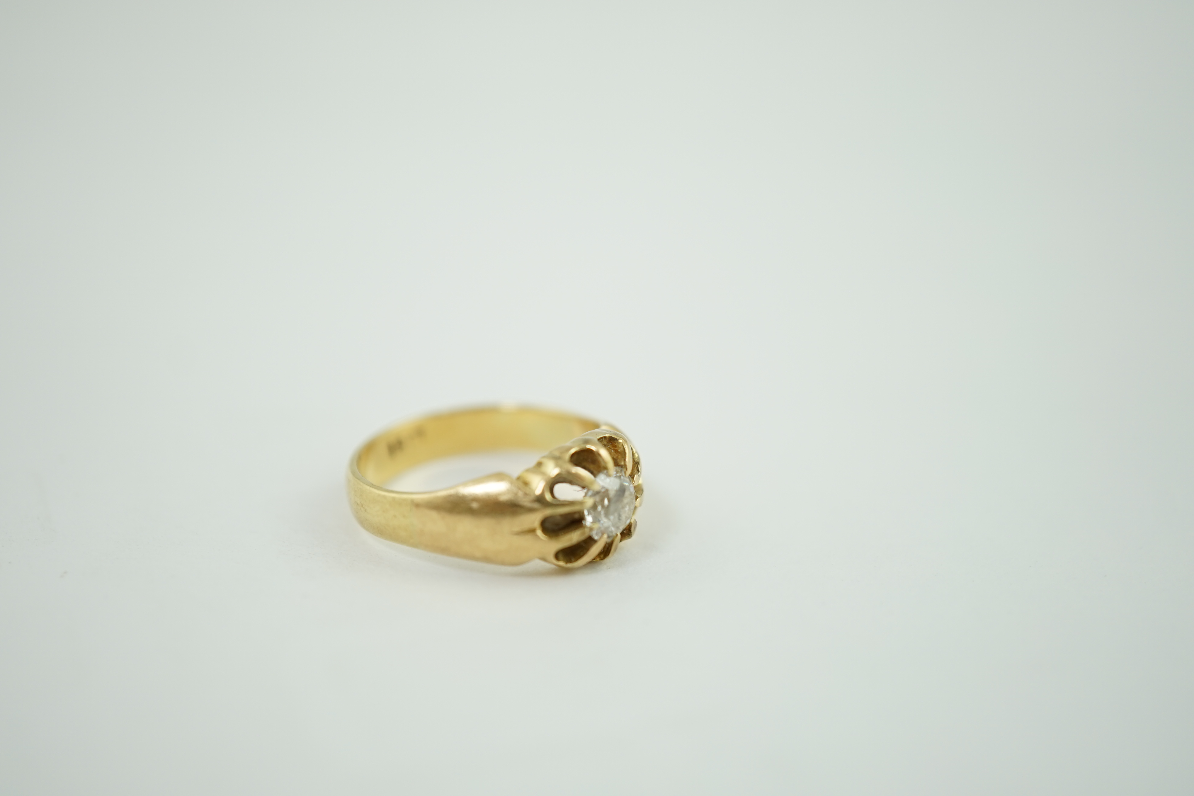 An early 20th century 18ct gold and claw set solitaire diamond ring